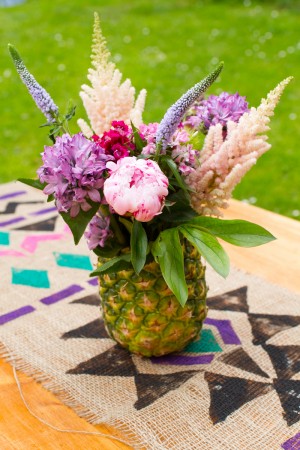 A pineapple vase adds flavor to table decor.