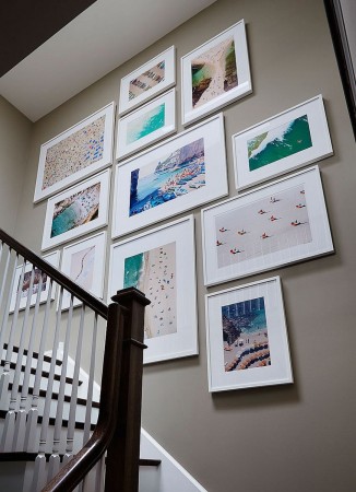 A collection of photographs displayed in the stairwell draws interest