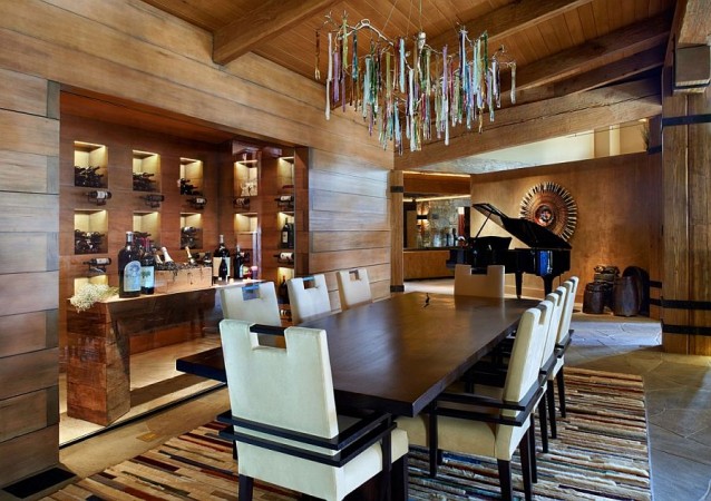 A dining room with wood paneled walls exuding the comfort of lodge style interiors.