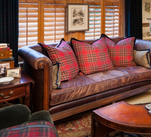 Classic tartan plaid pillows accent a leather sofa 