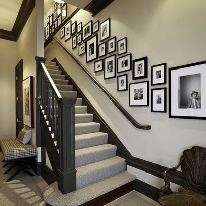 A staircase with framed pictures and a bench, creatively designed.