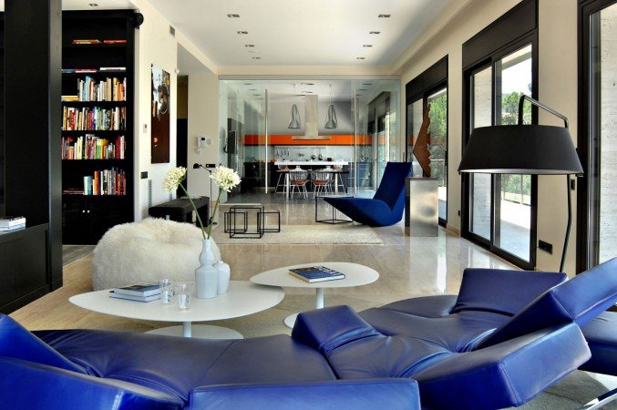 A futuristic blue leather chair in a living room.