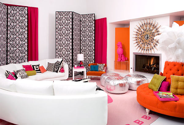 A living room decorated in orange and white with a Designer Focus on Jonathan Adler.
