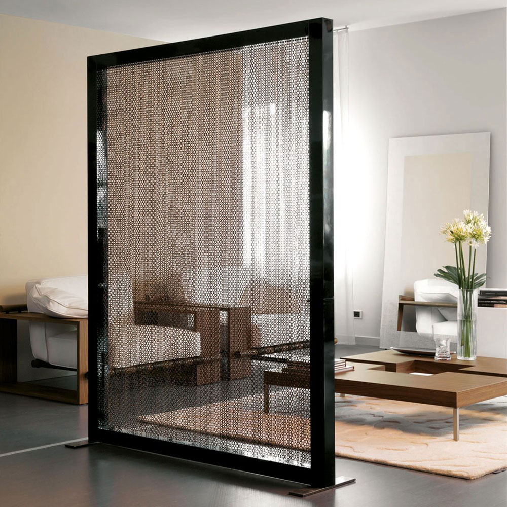A unique room divider with a mesh screen adding functional style to a living room.
