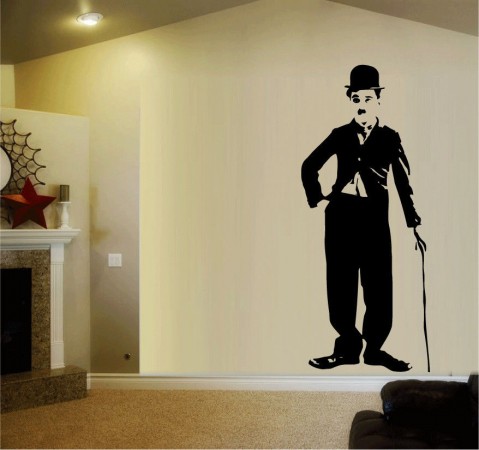 A living room with a wall sticker of a man in a top hat.