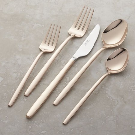 A rose gold flatware set with a spoon and fork to increase the heat with rose gold décor.