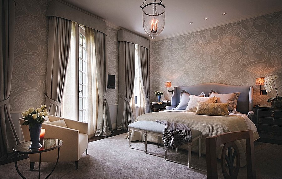 A sophisticated bedroom with a bed and a lamp.