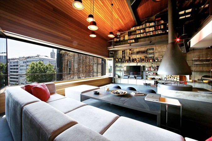 A modern living room with a large window and bookshelves, incorporating masculine industrial style.
