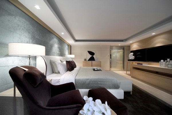 A modern bedroom with a large bed and Haute Couture interior design.