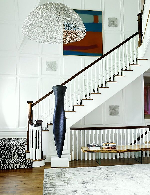 Unique lighting, artwork and a patterned runner enhance this stairwell