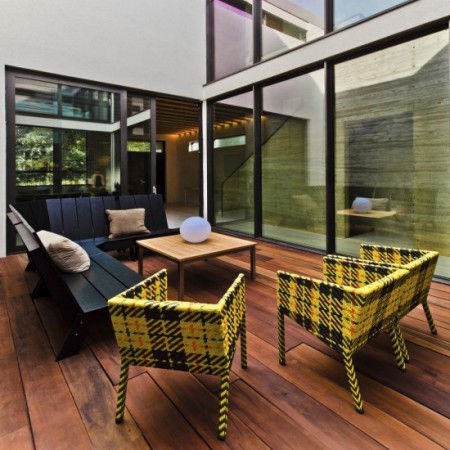 A modern patio with glass walls.