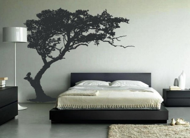 A black and white bedroom with a tree wall decal and wall stickers.