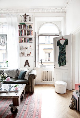 A living room with bookshelves and a couch in Provincial Parisian homes.