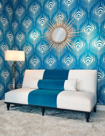 A living room with inspiring blue and white peacock feather wallpaper.