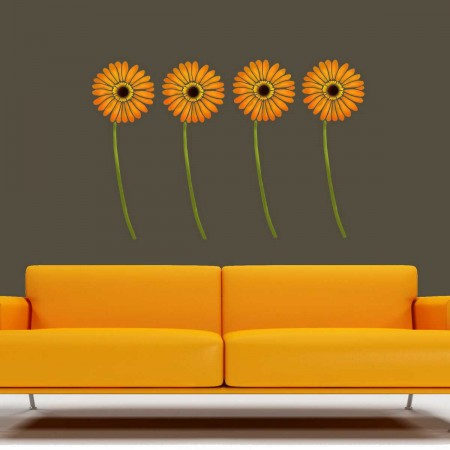 A yellow couch with wall stickers in a living room.