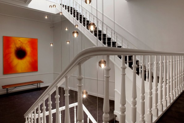 A multi-level light fixture adds drama and interest to the stairwell 