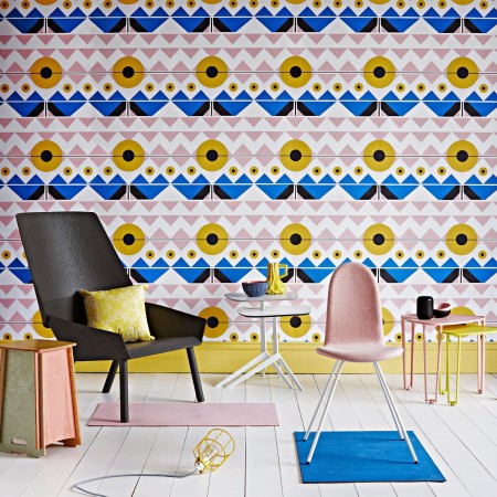 A room with vibrant pink and blue wallpaper reminiscent of the Swinging Sixties.