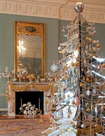 A gold and silver Christmas tree in a room decorated with alternative colors.