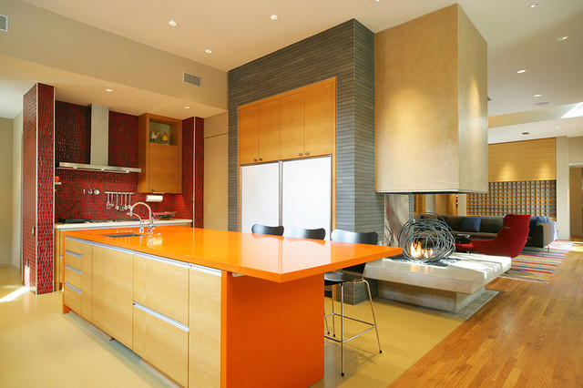 Bright orange countertops enliven this kitchen