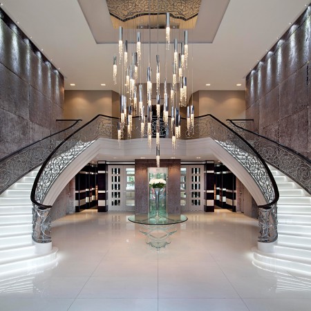 A grand lobby adorned with a magnificent chandelier exuding an air of haute couture interior design.