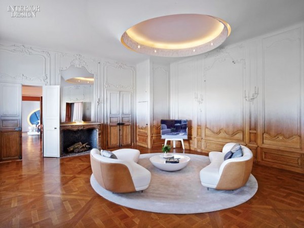 A living room with a round table and chairs featuring Haute Couture Interior Design.