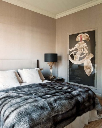 Fashionable bedroom with fur blanket