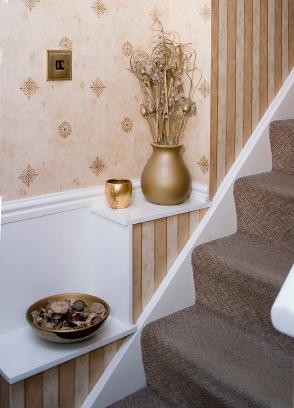 A staircase adorned with a vase of flowers.