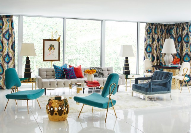 A living room with blue and gold furniture designed by the King of Happy Chic.