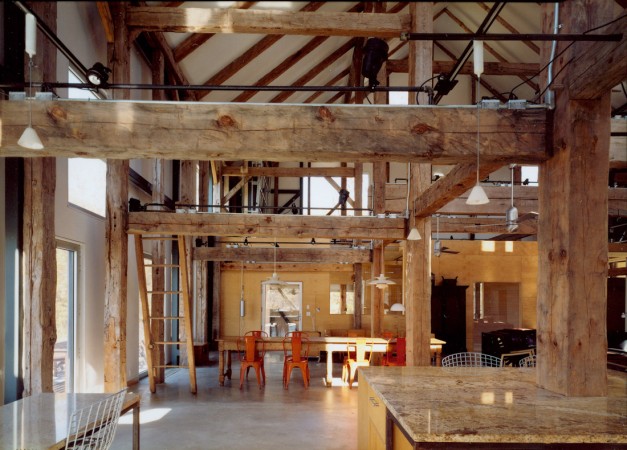A masculine room with wooden beams and an industrial-style kitchen for the modern man.