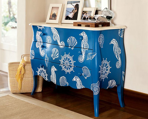 Give New Life to Old Furniture With Paint: A repainted blue dresser with seashells on it.