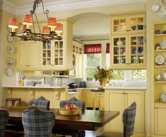 Blue plaid chairs are a charming addition to this yellow kitchen