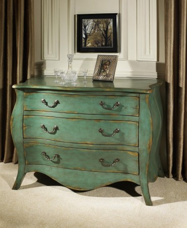 Give new life to old furniture with a green chest of drawers in a room with a picture.