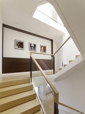 A framed collection of artwork brings interest and dimension to the stairwell 