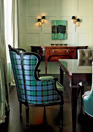 A plaid chair in a dining room.