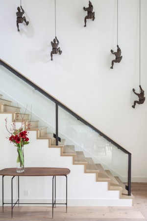 A staircase creatively adorned with metal sculptures.