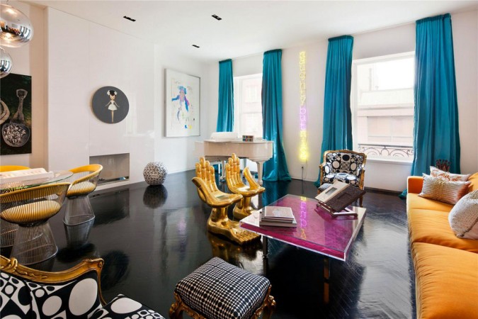 A brightly colored living room with black furniture designed by Jonathan Adler, the King of Happy Chic.
