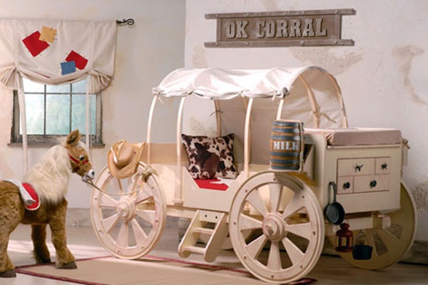 A wooden wagon bed with a horse next to it, perfect for kids rooms.