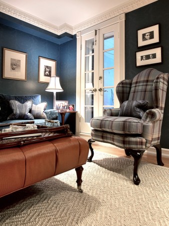 A cozy living room with blue walls and a plush couch perfect for snuggling up.