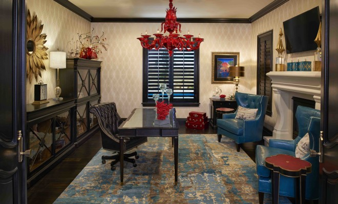 A haute couture home office featuring blue chairs and a chandelier.