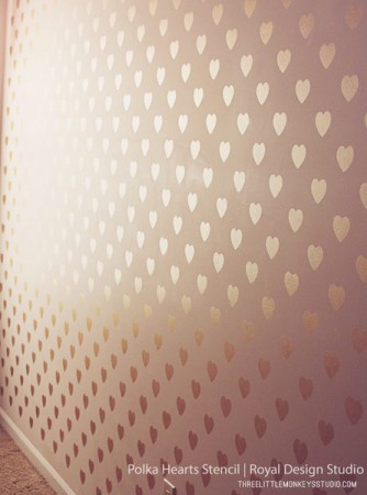 A room with rose gold hearts on the wall.