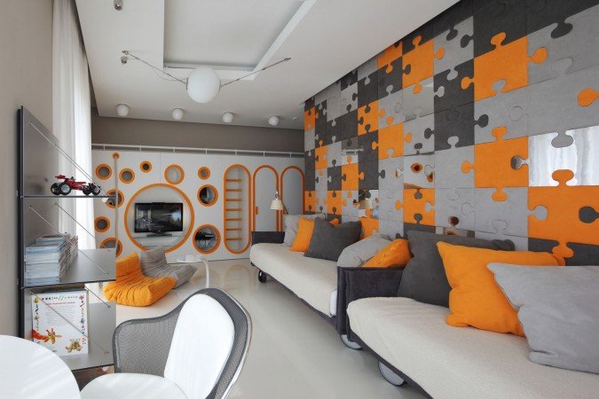 An orange and gray living room with puzzle pieces on the wall, exploring futuristic interior design.