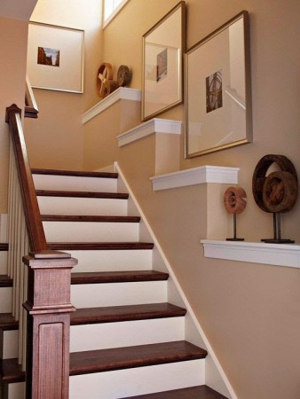 Seven Creative Ways to Design a Stairway with Framed Pictures and a Wooden Railing.