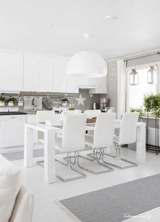 A white kitchen with a painted white floor.