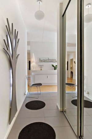A hallway with a mirror.