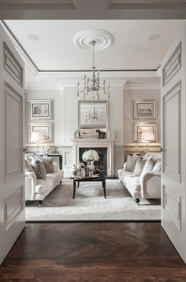 A large living room with white furniture and hardwood floors, showcasing the elegance of Provincial Parisian homes.