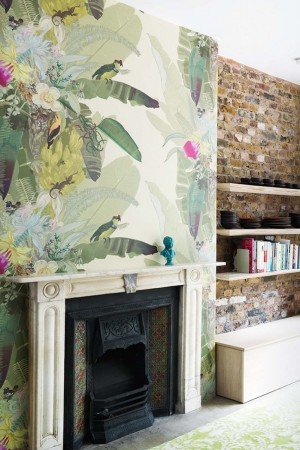 Creating a tropical paradise in the living room with a fireplace and vibrant wallpaper.
