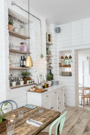 A rustic kitchen with a wooden table and chairs.