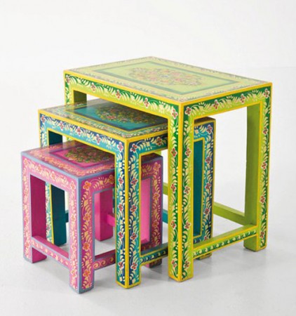 A set of colorful painted nesting tables, giving new life to old furniture.