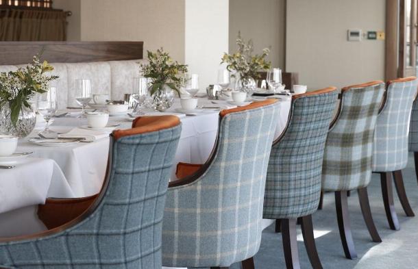 A mix of heather gray plaid chairs add character to this dining area