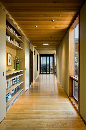 A hallway with bookshelves and a view.